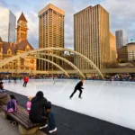 Skaters on rink at Nathan Phillips Square, Toronto