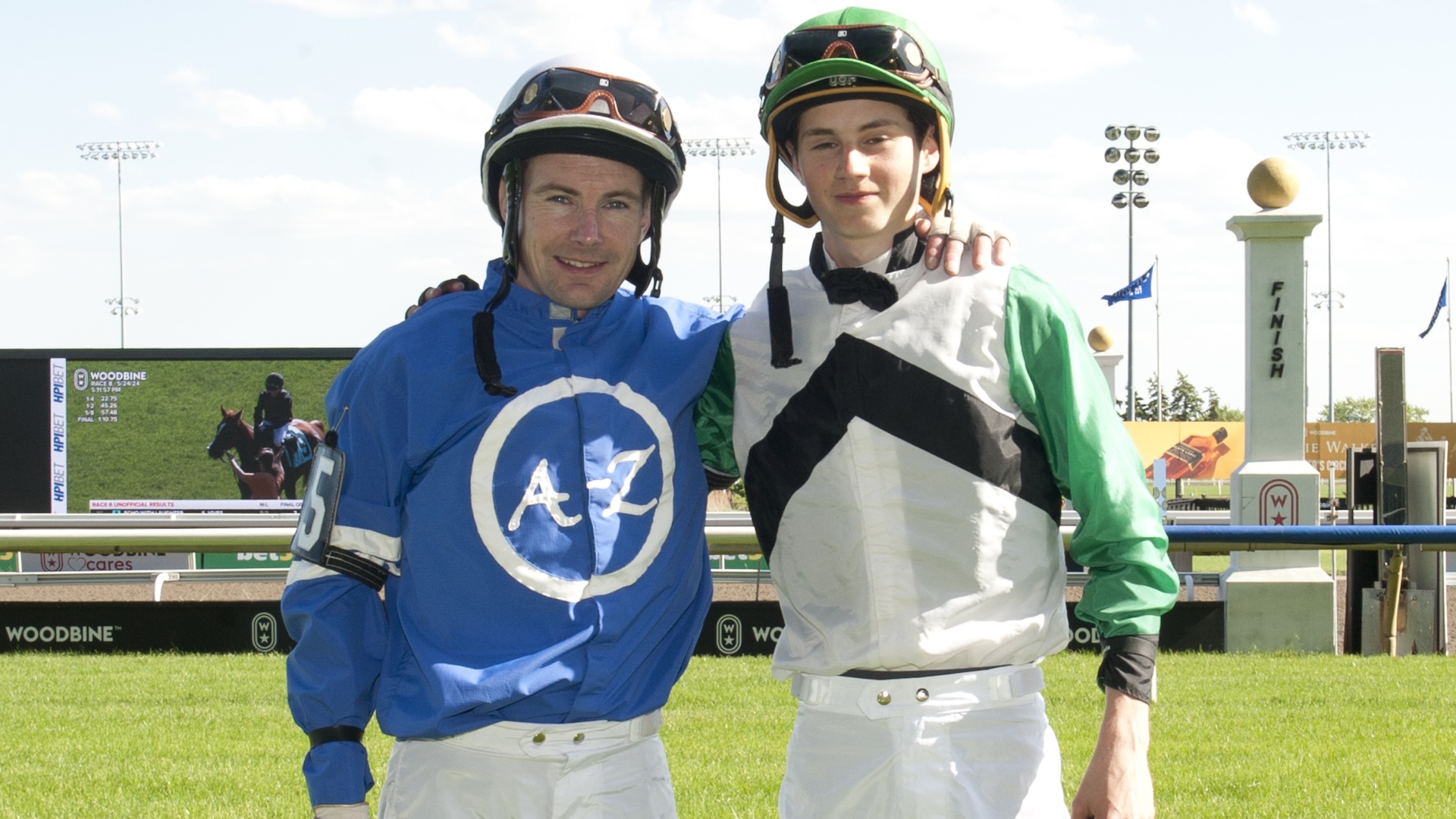 Toronto ON May 24, 2024 Woodbine Racetrack Race #8,Jockey's (Father L) David Moran #5,Race for Pinks, (blue silks), and son Pietro Moran (#2 King Alfredo, White silks green black) break from starting gate for the 1st time riding against each other at Woodbine Racetrack Woodbine/Michael Burns Photo