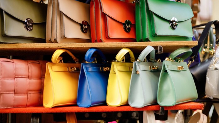 Close up of different leather bags on market Modern colorful bags for sale Womanly accessories Close up of different leather bags on market Modern colorful bags for sale Womanly accessories