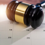 Wooden judge gavel on calendar