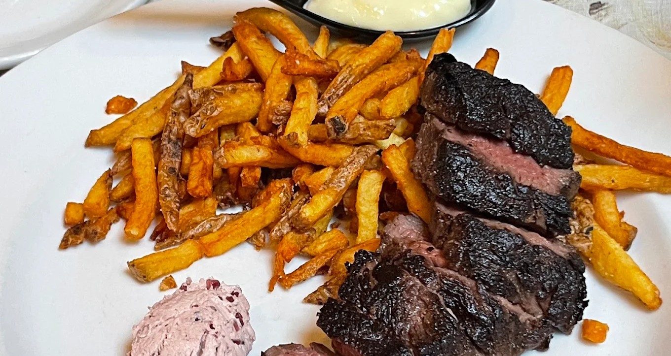Canadian Prime Striploin steak frites with Yukon Gold frites and house-made tarragon mayo at La Palette Queen West.