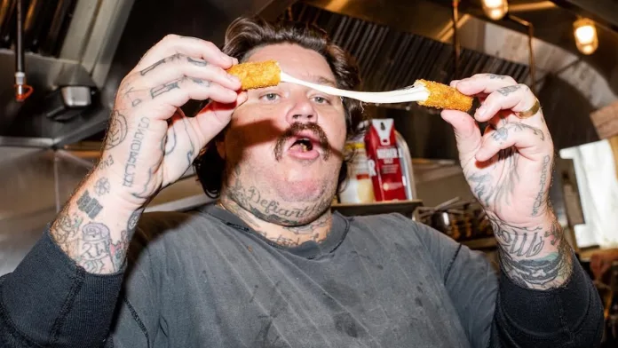 Matty Matheson demonstrating the cheese pull at Rizzo's