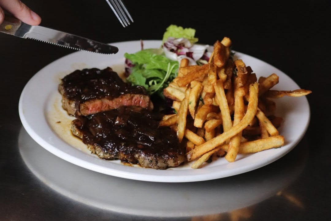 Wednesday night steak frites special with 48-hour shallot peppercorn sauce and a glass of wine at Le Baratin.