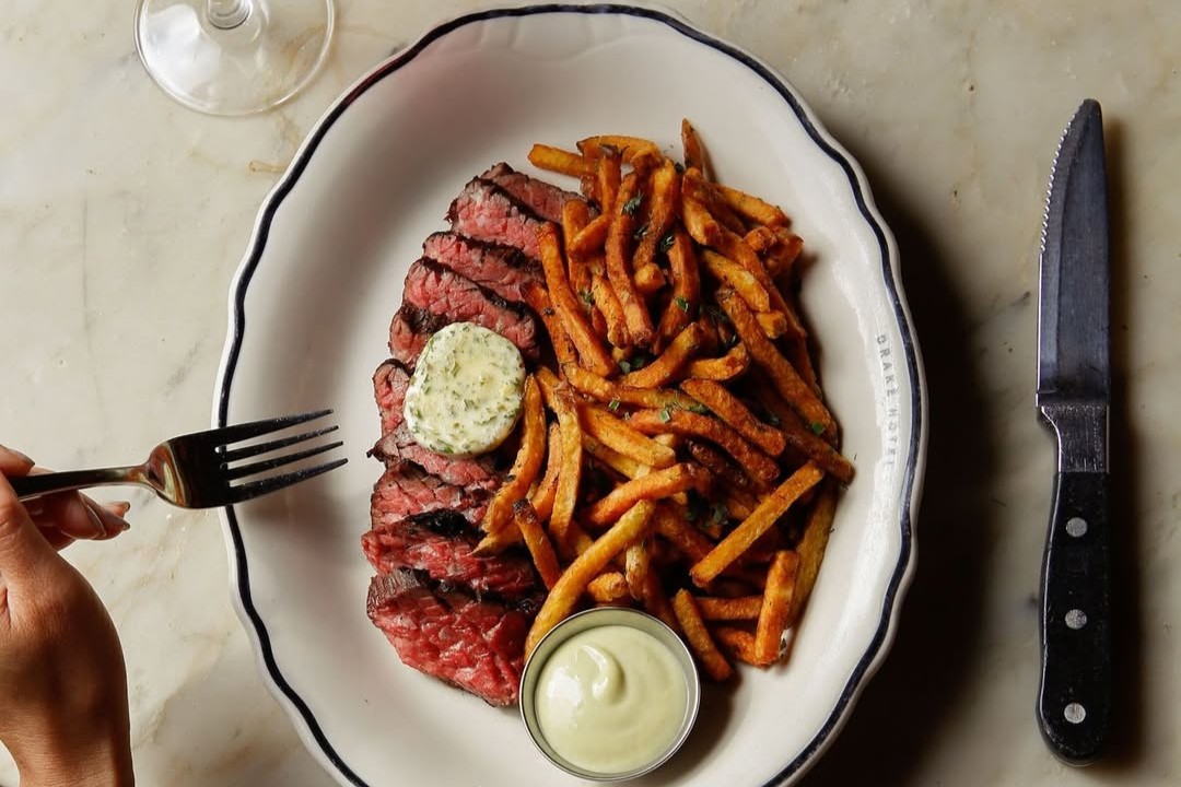 Monday night steak frites special featuring a beefy bavette cut and smoky whiskey peppercorn sauce at The Drake Hotel.